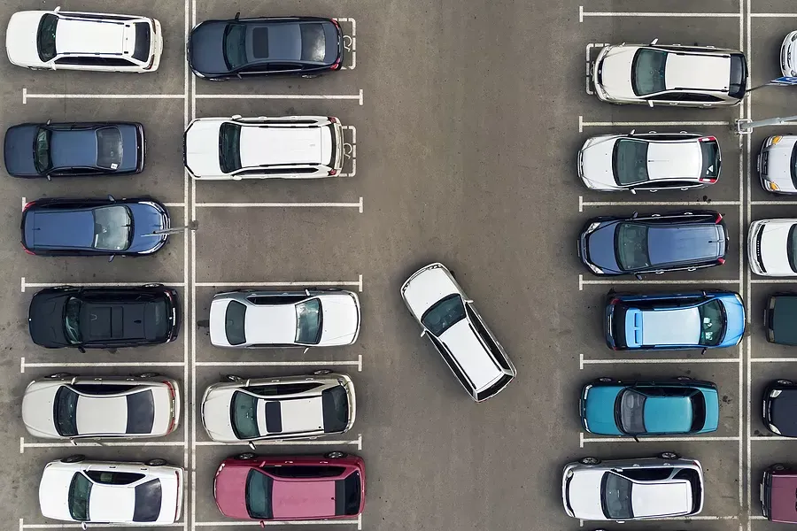 Overhead view of a parking lot as a car is pulling into one remaining spot